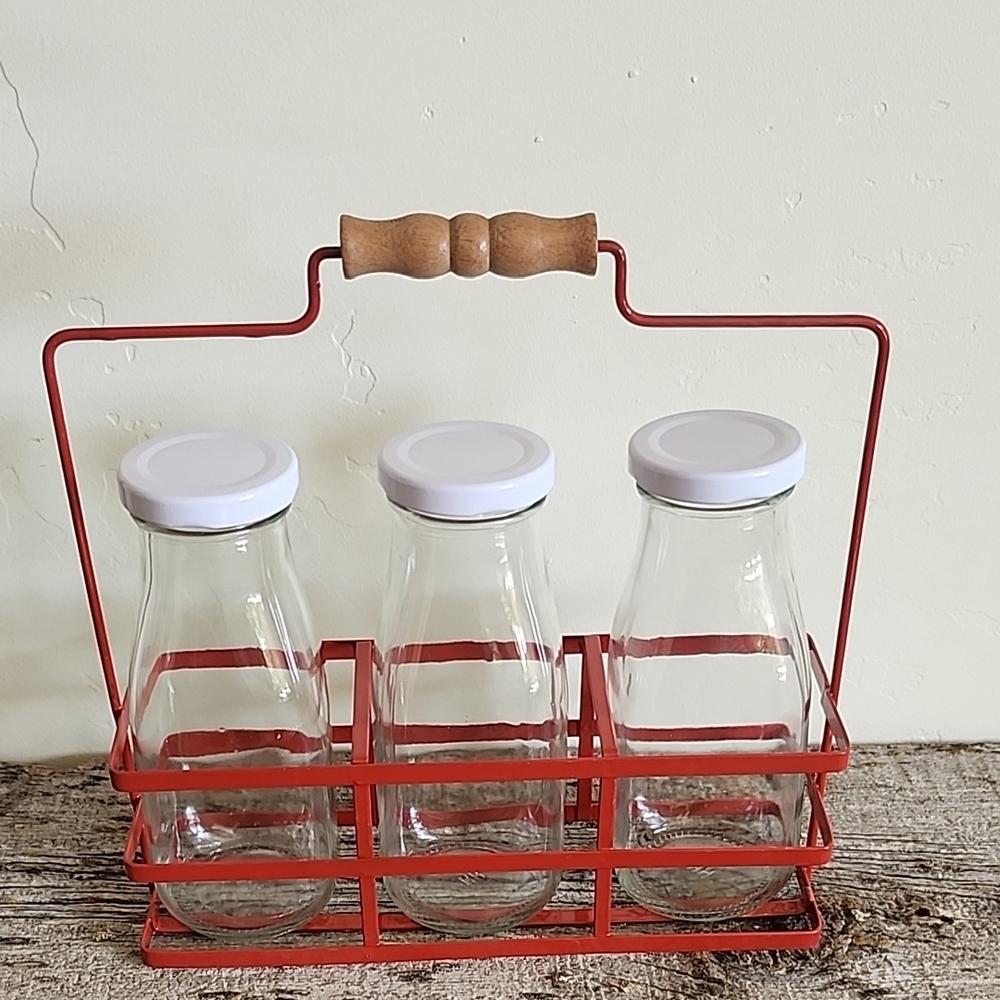 Glass Milk Bottles with White Lids in Red Metal Carrier